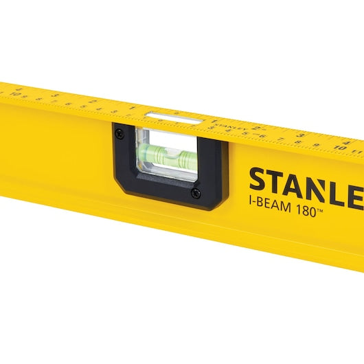 Close-up of a yellow STANLEY 42-328 48 in. Heavy Duty Aluminum I-Beam Level, featuring a central 180 rotating vial for leveling. This robust tool includes measurement markings along the top edge, designed to withstand demanding tasks with its durable construction.