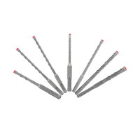 The DIABLO DMAPL9920-S7 7-Piece Rebar Demon™ set by Diablo showcases silver SDS-Plus 4-cutter full carbide head hammer bits in a fan shape on a green background. Each has a red tip and twisted design with Tri-Metal Diffusion Bonding for superior masonry or concrete performance.